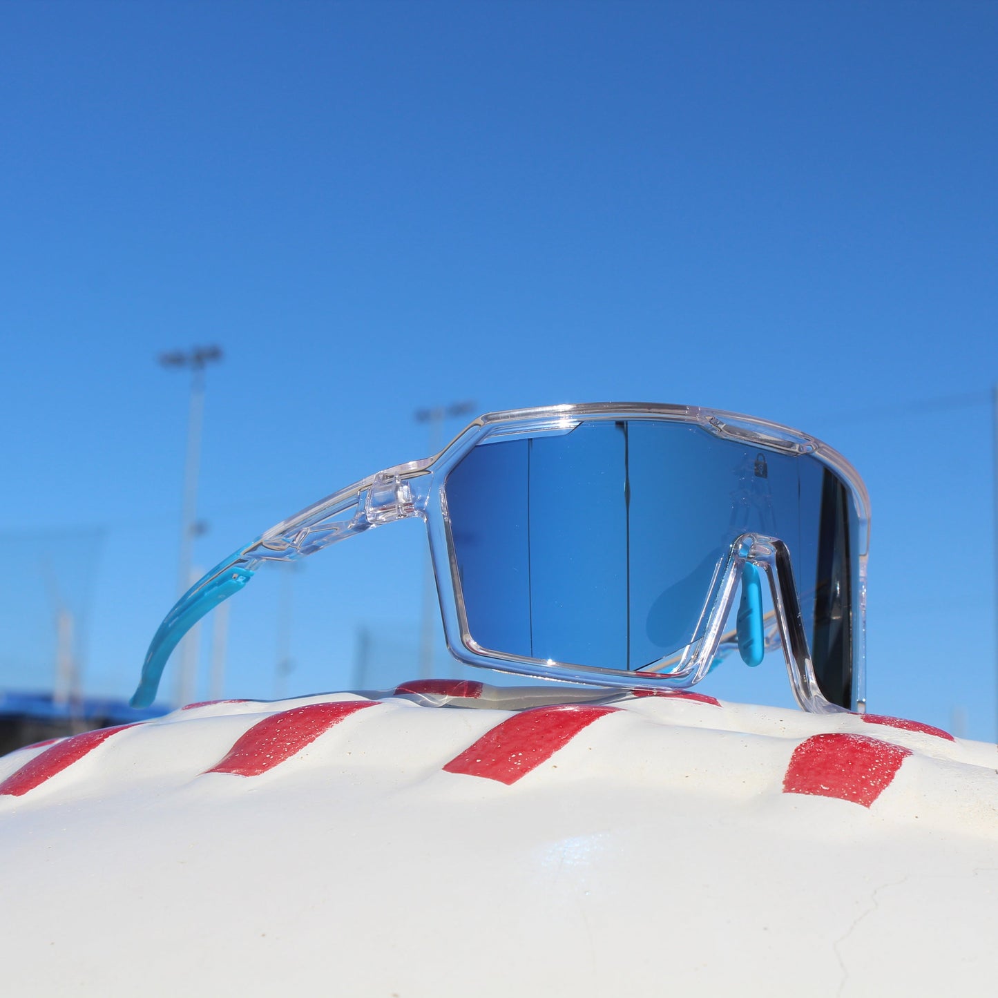 Slickslider Polarized Baseball Sunglasses from Locked Eyewear with a reflective blue lens.