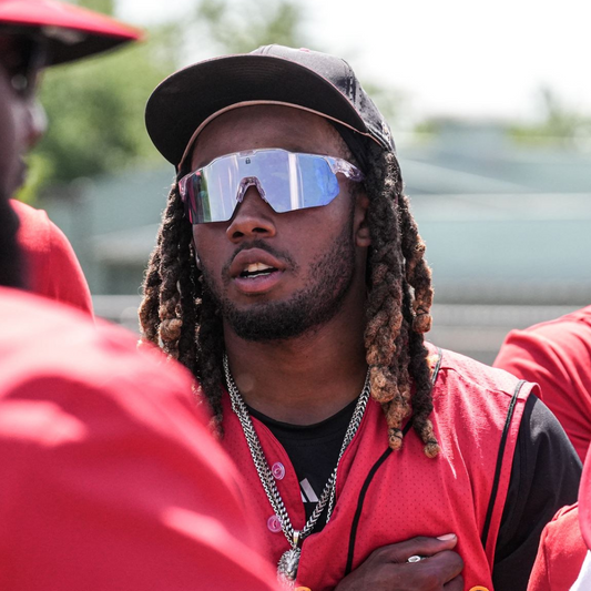 Image of professional baseball player on a sunny baseball field protecting his eyes from sun damage with Locked Eyewear PA10 model featuring high quality athletic design.