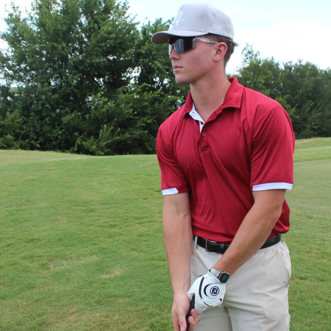 Professional golfer on the course wearing Locked performance baseball sunglasses.