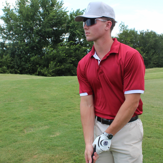 Professional golfer on the course wearing Locked performance baseball sunglasses.