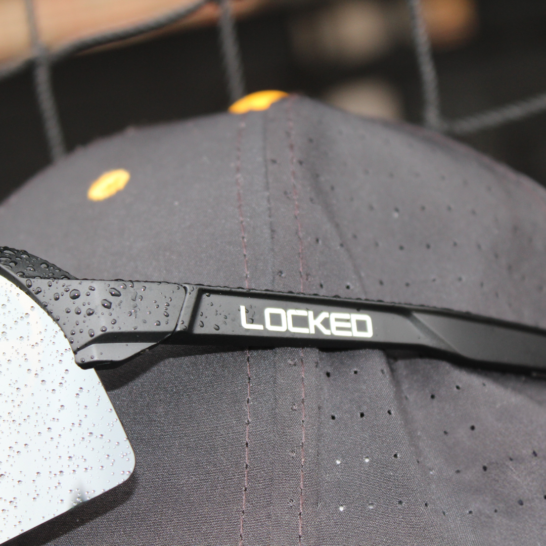 Image of PA10 Pro Series Sport Sunglasses from Locked Eyewear sitting on a baseball hat.