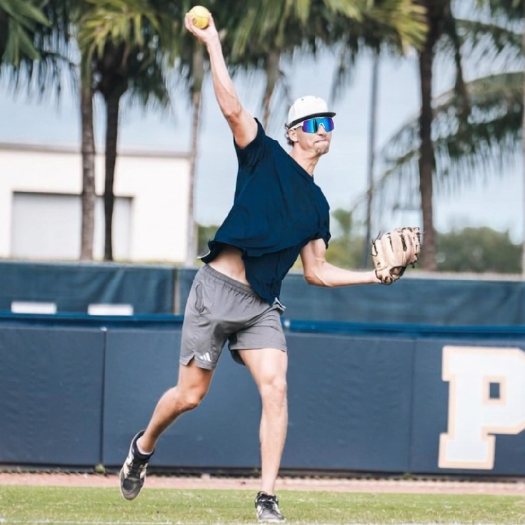 Locked Eyewear Awaken baseball sunglasses worn by professional baseball pitcher in throwing motion on the mound white Frame reflective blue lens e-signed for elite performance during competitive game