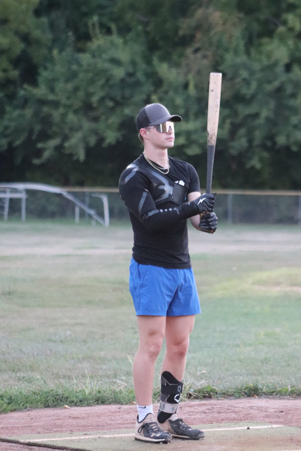 Youth baseball player fielding ground balls wearing pro-grade baseball sunglasses by Locked Eyewear