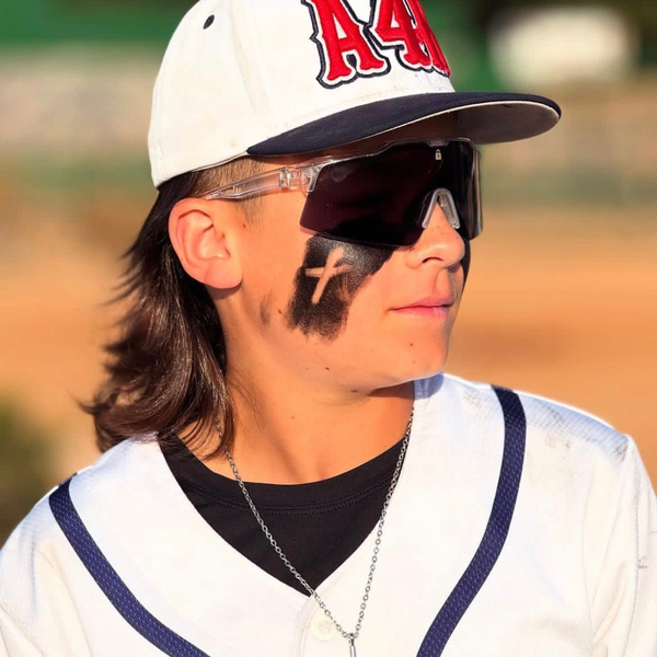 Baseball player wearing Locked Eyewear performance baseball sunglasses during pregame warm-ups on the field