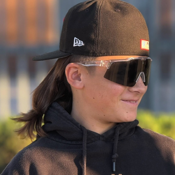 Teen baseball athlete wearing baseball sunglasses with mirrored lenses for bright conditions