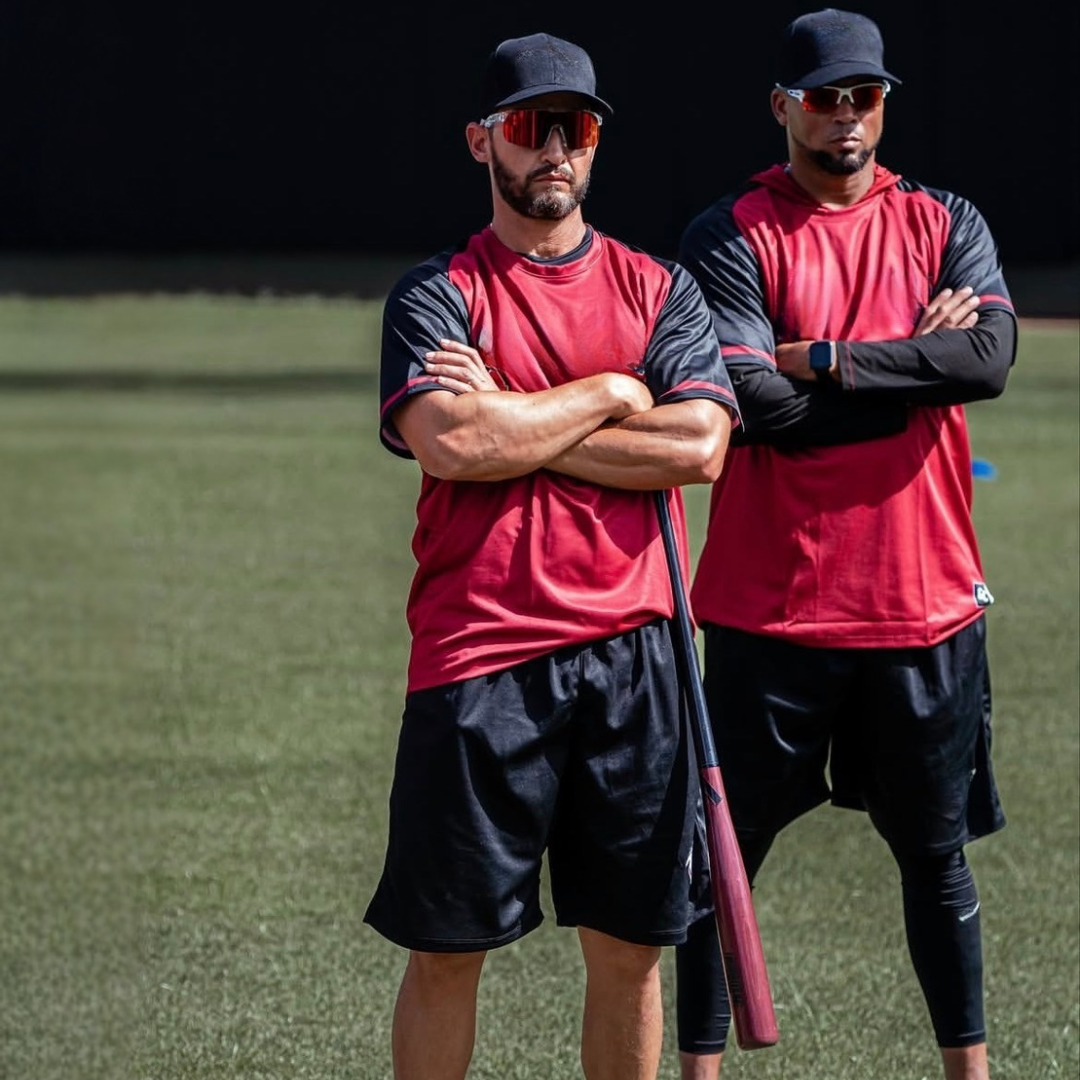 Professional baseball coach running a practice looking fiercely at his players wearing Locked Revelation baseball sunglasses on a hot California day.